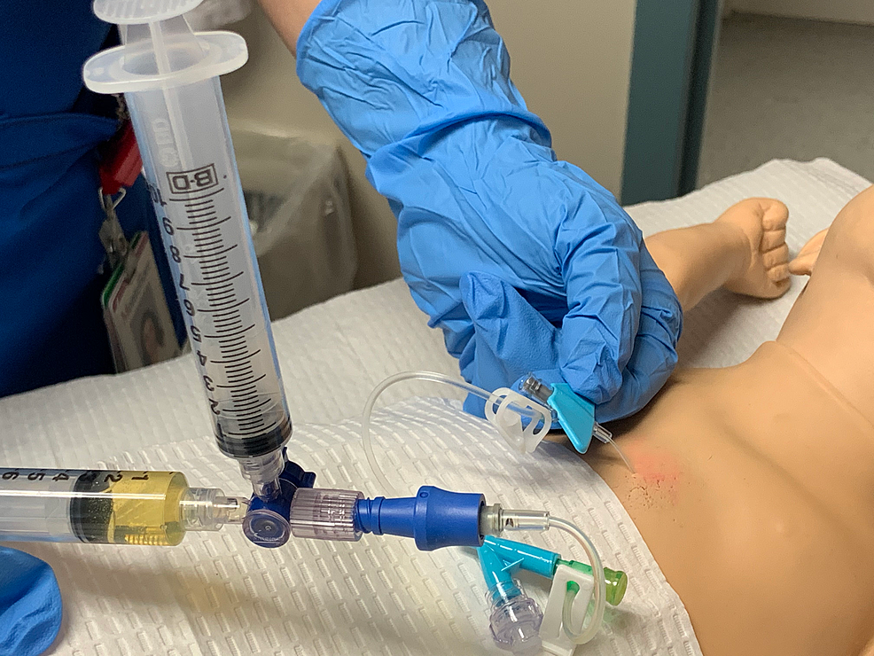Insertion-of-needle-into-model-to-simulate-pericardiocentesis