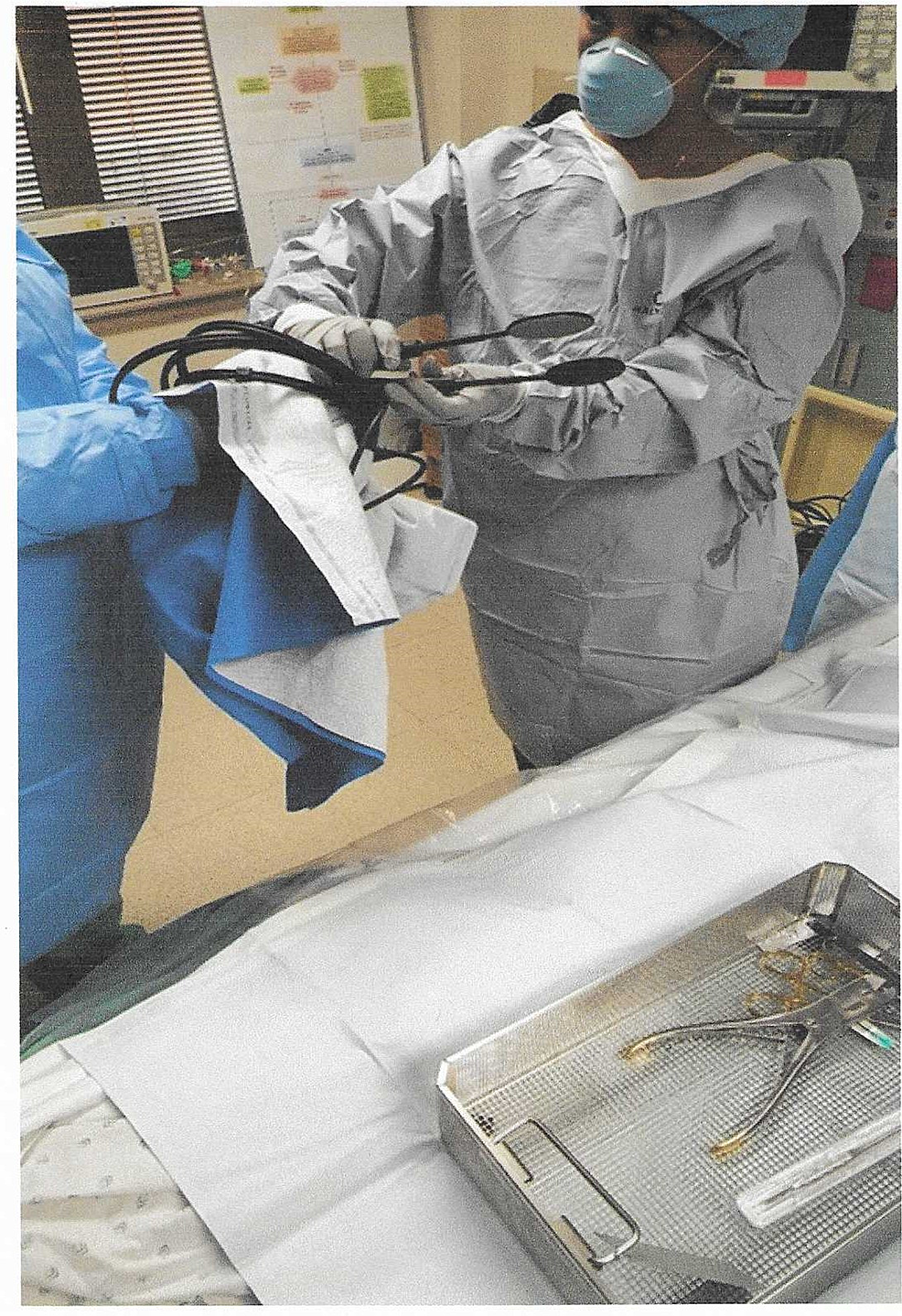 Circulating-nurse-handing-over-sterile-equipment-to-the-surgeon.